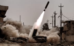 Iraqi troops fire artillery towards Islamic State (IS) jihadists' positions in west Mosul.