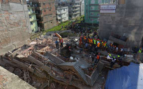 Rescue teams search for survivors at a collapsed building in Kathmandu.