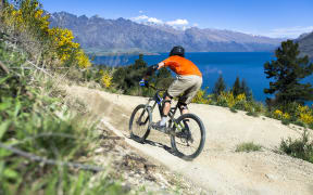 Mountain bike rider on bike path in Queenstown, New Zealand