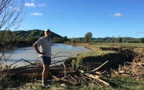 Kevin Clark next to some of the flood damage on his property next to the Waimana River.