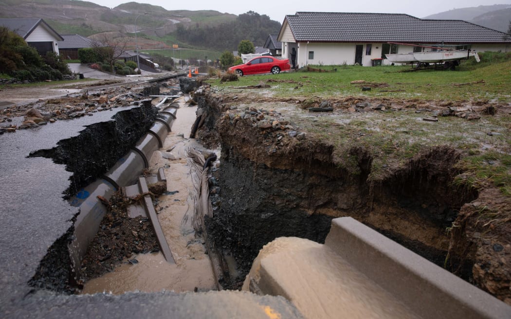 Flood waters have ripped open the road in Devenish Place, Atawhat, just north of Nelson