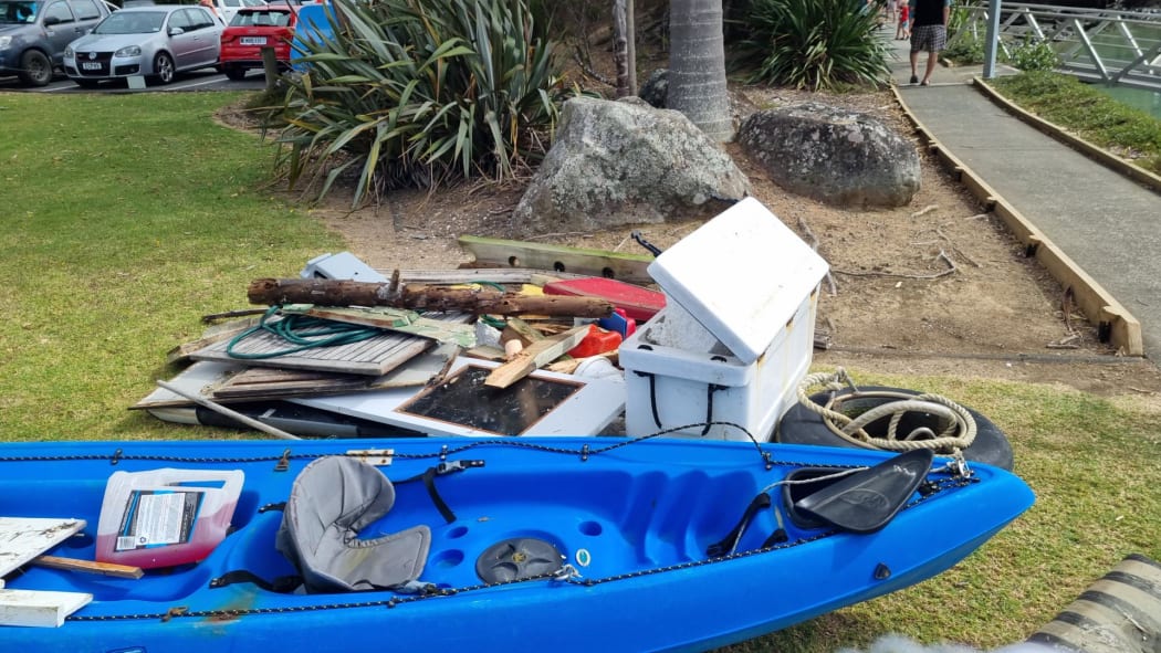 Debris pulled out from Tūtūkākā Marina after strong tidal surges caused damage to boats.
