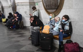 People take shelter in a metro station in Kyiv on the morning of February 24, 2022.
