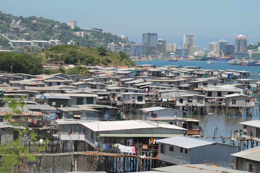 Hanuabada, the original village of Papua New Guinea's capital city Port Moresby inhabited by the Motuan people; with the CBD in the background.