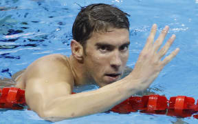 Michael Phelps celebrates winning his 22nd Olympic Games gold medal, and his fourth gold at Rio after winning the 200m medley.
