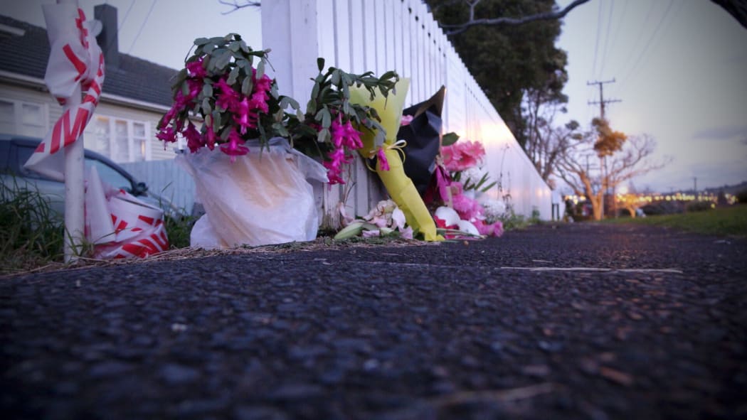 Police cordons and flowers on Tuesday at the house in Onehunga where Maggie Renee Watson was found.