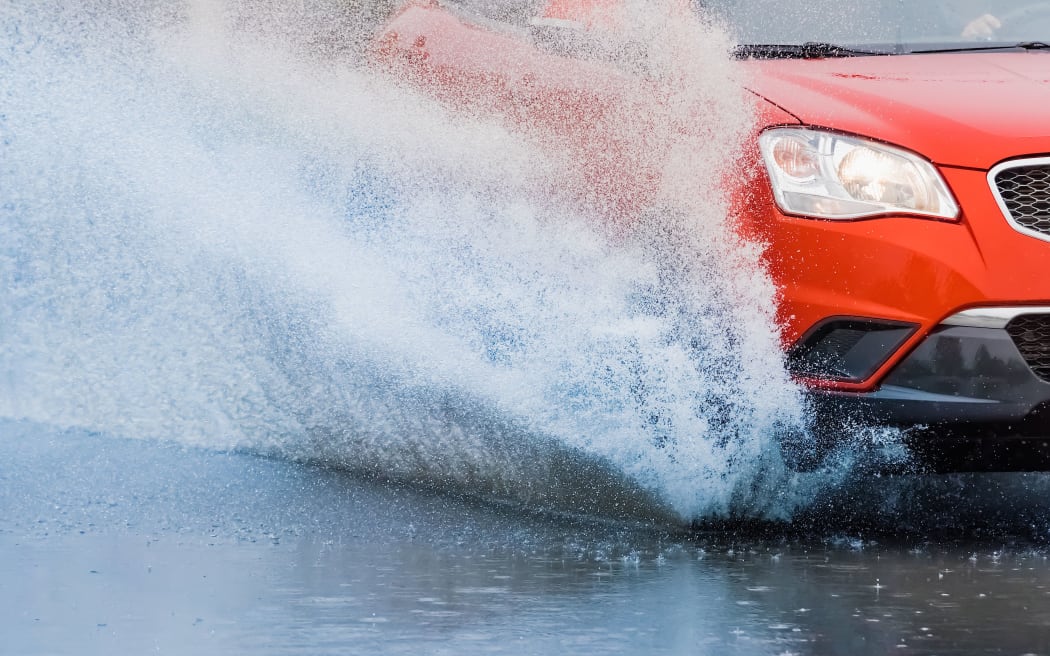 motion car rain big puddle of water spray from the wheels