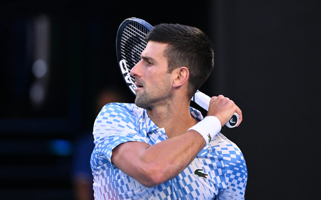 Serbia's Novak Djokovic serves against USA's Tommy Paul during their men's singles semi-final match on day twelve of the Australian Open tennis tournament in Melbourne on January 27, 2023. (Photo by WILLIAM WEST / AFP) / -- IMAGE RESTRICTED TO EDITORIAL USE - STRICTLY NO COMMERCIAL USE --
