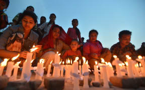A candle lit vigil in Kathmandu on 25 May, a month after the deadly earthquake struck the Himalayan nation.