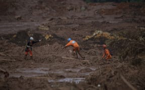 Rescuers search for vicitms in the mud-hit community of Casa Grande two days after the collapse of a dam at an iron-ore mine belonging to Brazil's giant mining company Vale near the town of Brumadinho, state of Minas Gerias, southeastern Brazil, on January 27, 2019.