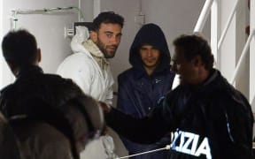 Mohammed Ali Malek (L), the captain of the migrant boat that capsized in the Mediterranean sea killing 700, pictured on the Italian coastguard's ship after being rescued.