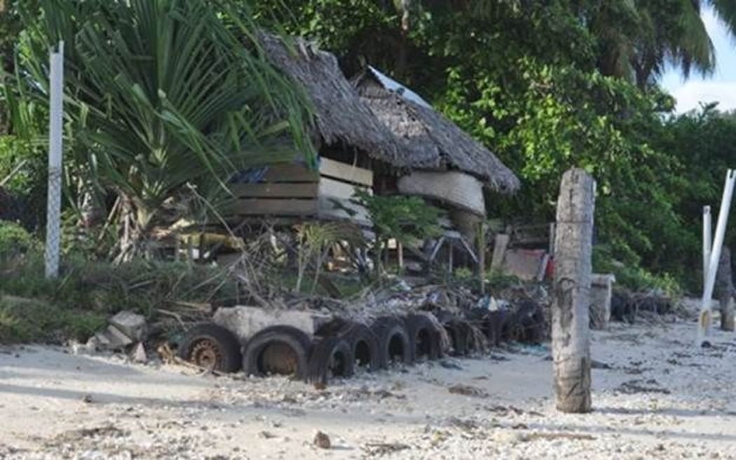A seawall protecting a home from coastal erosion in Kiribati, climate change.