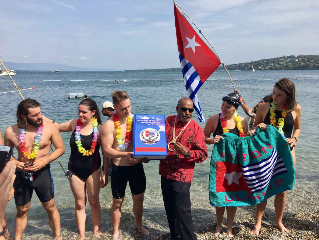 Benny Wenda with the Swim for West Papua Team at the Finish, Bains des Paquis, Geneva, with the Petition.