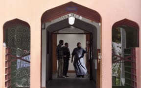 Members of the local Muslim community inspect the interior of the Al Noor Mosque after it was reopened.
