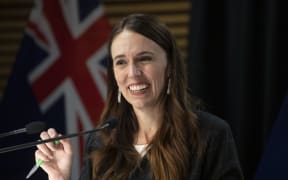 - POOL - Photo by Mark Mitchell.  Prime Minister Jacinda Ardern smiling during the post-Cabinet press conference with Energy Minister Megan Woods and Finance Minister Grant Robertson, Parliament, Wellington. 14 March, 2022.  NZ Herald photograph by Mark Mitchell