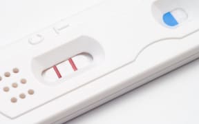 A home pregnancy test showing a positive result.