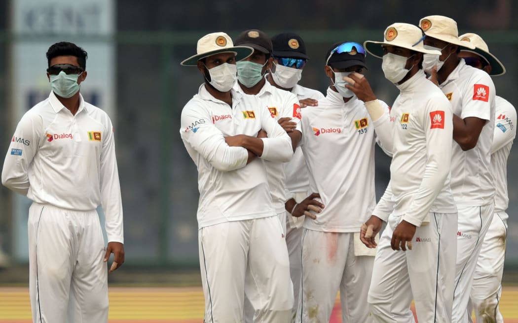 Sri Lankan cricketers wear face masks to protect themselves from smog in their Test against India in Delhi.
