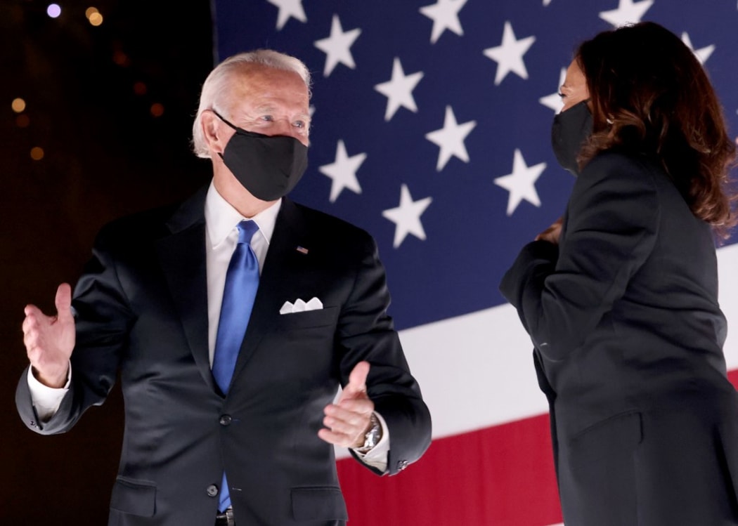Democratic presidential nominee Joe Biden and Democratic Vice Presidential nominee Kamala Harris confer on stage outside the Chase Center after Biden delivered his acceptance speech  in Wilmington, Delaware.