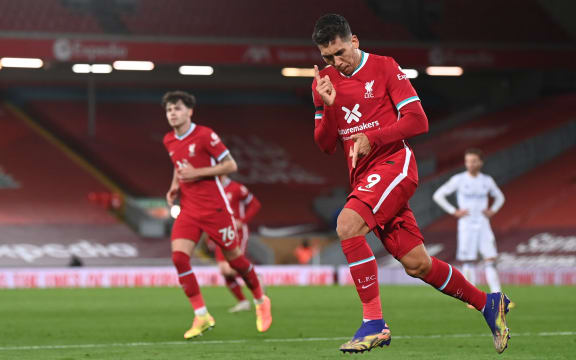 Liverpool's Brazilian midfielder Roberto Firmino celebrates after scoring a goal during the English Premier League football match against Leicester City at Anfield in Liverpool, north west England on November 22, 2020.