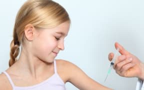 Doctor immunises young girl