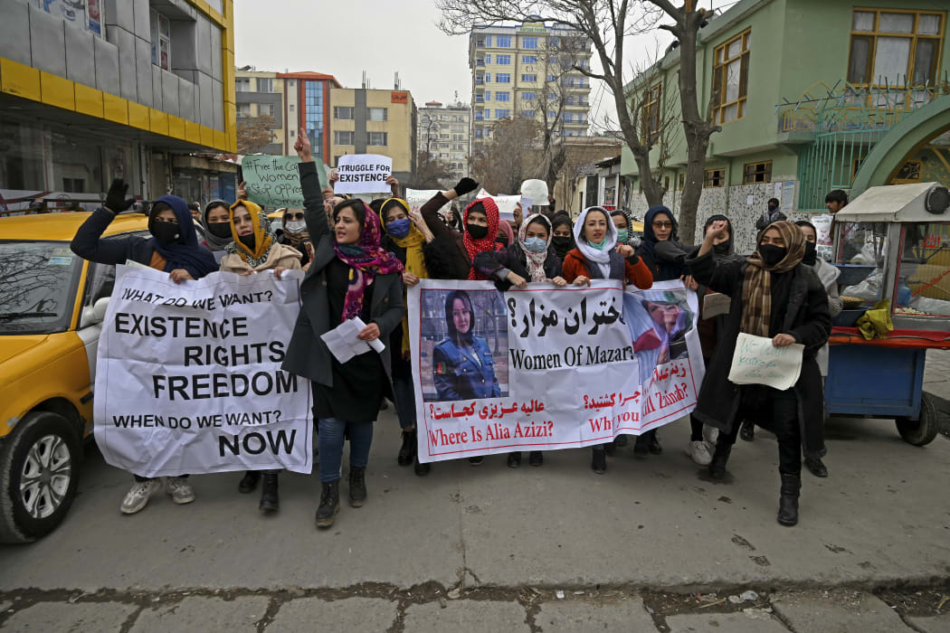 Afghan women march as they chant slogans and hold banners during a women's rights protest in Kabul on 16 January, 2022.
