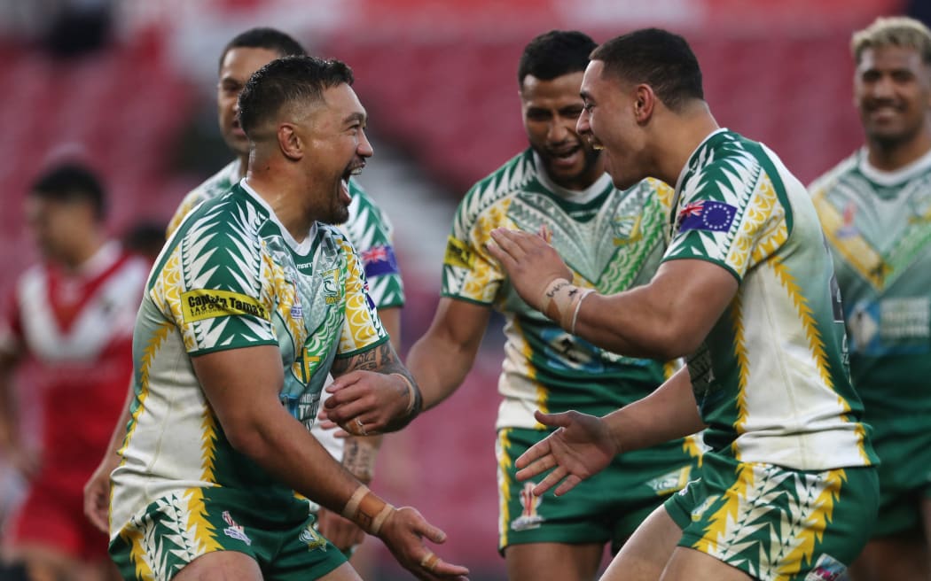 Cook Islands' Tinirau Arona celebrates after scoring their second try against Tonga