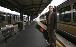 Anthony Tonnon waiting for the train on his Rail Lands tour