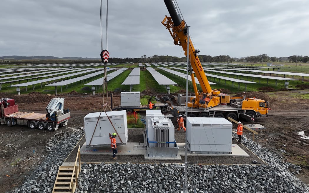 One of six inverters is craned into position at Lodestone Energy's Kaitāia solar farm. The inverters convert the panels' low-voltage DC output into high-voltage AC power suitable for transmission. Photo: Lodestone Energy
