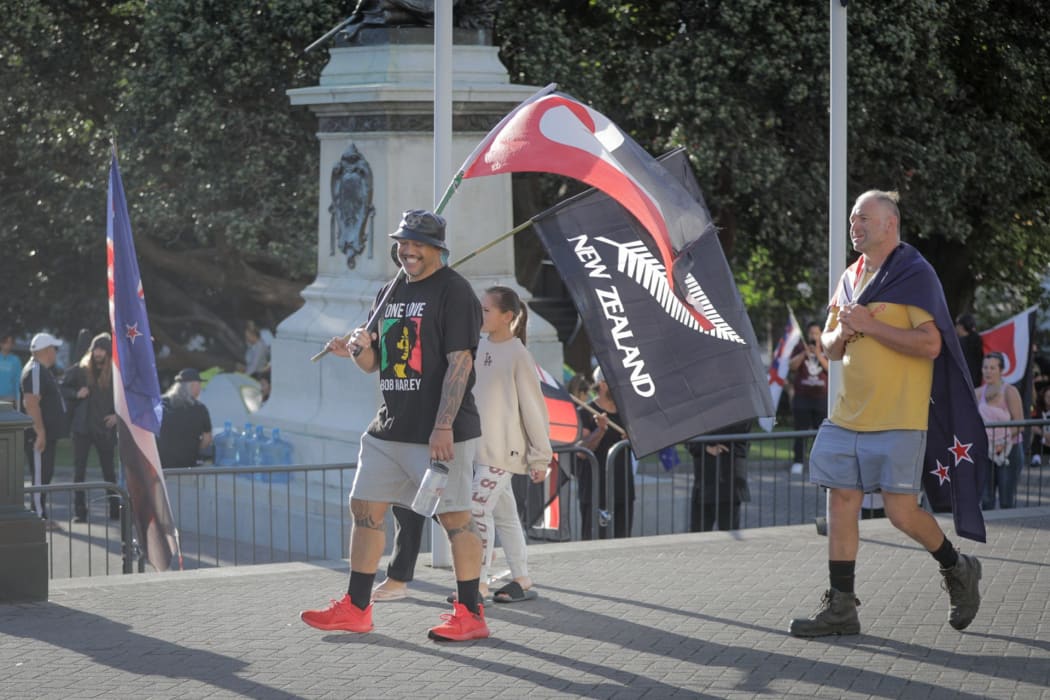 Protesters against Covid-19 vaccine mandates were carrying flags and signs.