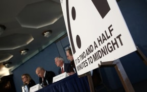 Members of the Bulletin of Atomic Scientists unveil the 2017 time for the "Doomsday Clock" on January 26, 2017 in Washington, DC.