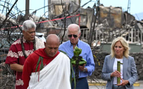 US President Joe Biden and US First Lady Jill Biden participate in a blessing ceremony with the Lahaina elders at Moku'ula following wildfires in Lahaina, Hawaii on August 21, 2023. The Bidens are expected to meet with first responders, survivors, and local officials following deadly wildfires in Maui. (Photo by Mandel NGAN / AFP)