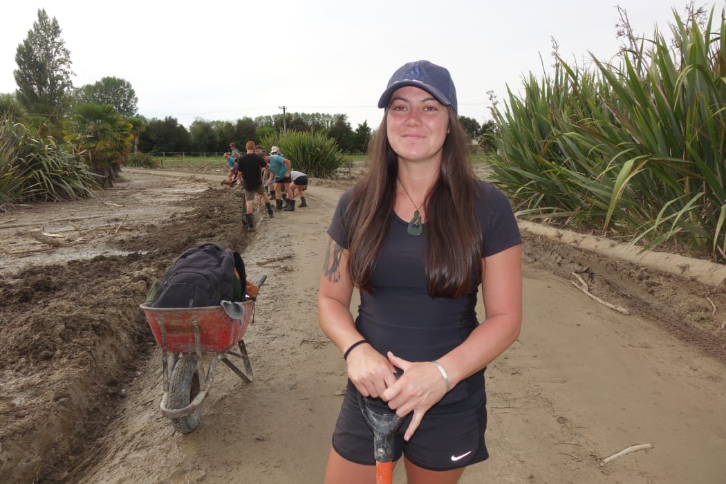 Student Kristiane Ellery volunteered to help dig homes out of the mud. She says it's a tough job, and not just physically.