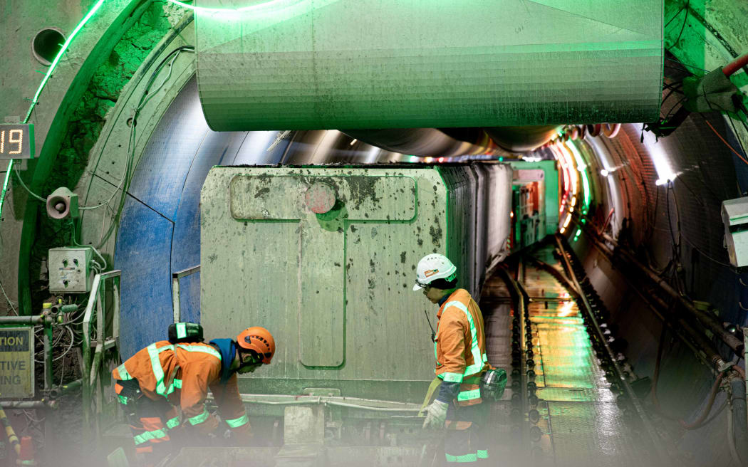 Workers prepare the tunnel boring machine to dig the tunnel for the central interceptor stormwater system under the Manukau Harbour.