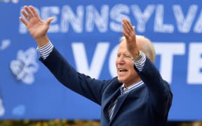(FILES) In this file photo taken on October 24, 2020, Democratic presidential candidate Joe Biden speaks at a drive-in rally on the Bucks County Community College's Lower Bucks campus in Bristol, Pennsylvania.