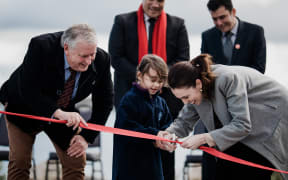 Labour Party leader cuts the ribbon with a girl, and Taupō Mayor David Trewavas during the leader's election campaign on 10 September, 2020.