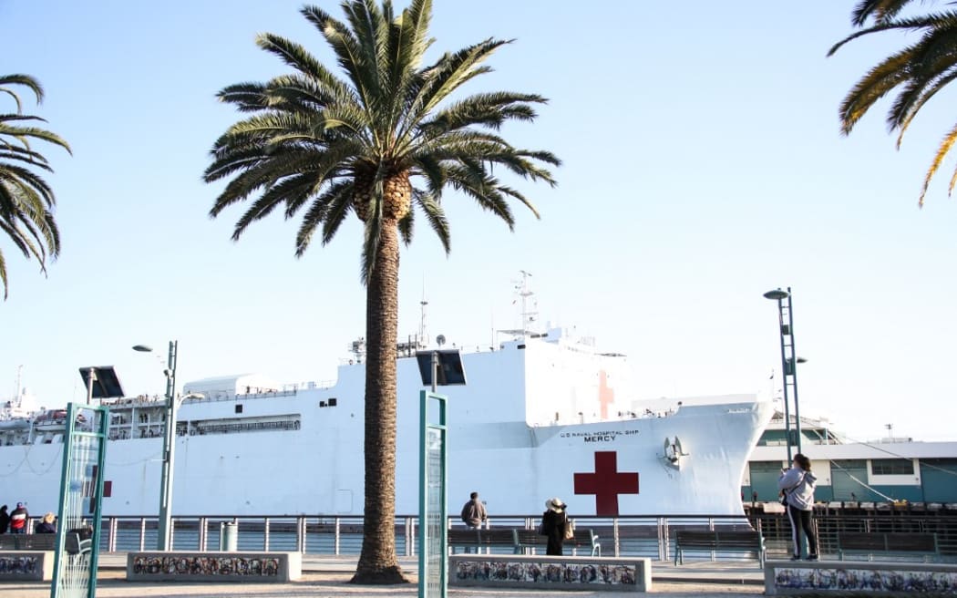 SAN PEDRO, LOS ANGELES, CALIFORNIA, USA - MARCH 27: United States Navy Hospital Ship USNS Mercy arrives at the Port of Los Angeles to assist with the coronavirus COVID-19 pandemic on March 27, 2020 in San Pedro, Los Angeles, California, United States. The ship holds 1,000 beds which will be used to treat non-coronavirus patients in an effort to free up hospital beds for those suffering from COVID-19. The ship's 800 medical personnel will help ease the burden on the region's hospitals as they grapple with the pandemic. (Photo by Xavier Collin/Image Press Agency/NurPhoto) (Photo by Image Press Agency / NurPhoto / NurPhoto via AFP)