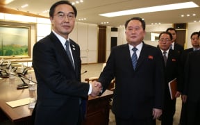 South Korea's Unification Minister Cho Myung-Gyun (L) shakes hands with North Korean chief delegate Ri Son-Gwon after their meeting at the border truce village of Panmunjom.
