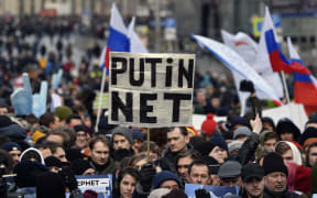 A protester holds a placard reading "Putin - No!" during an opposition rally in central Moscow, on March 10, 2019, to demand internet freedom in Russia.