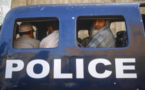 Detained Afghan refugees sit in a van during a search operation to identify alleged illegal immigrants, on the outskirts of Karachi on November 17, 2023. More than 200,000 people have crossed from Pakistan into Afghanistan, Pakistani border officials said, the vast majority since an October ultimatum given to the 1.7 million Afghans Islamabad said were living illegally in the country. (Photo by Asif HASSAN / AFP)