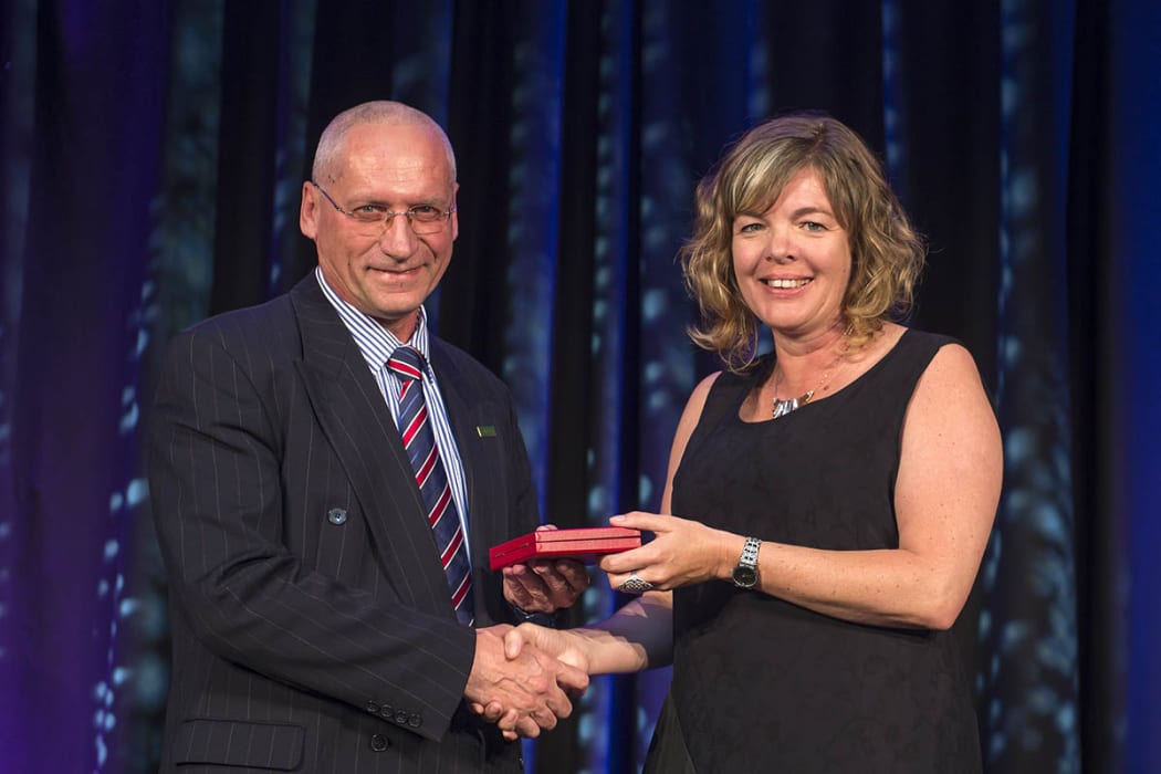 Professor Valery Feigin receiving his McDiarmid  medal from Professor Juliet Gerrard at the 2015 Royal Society of New Zealand Research Honours dinner