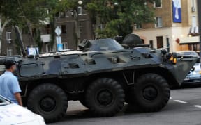 An armoured vehicle rides in the street in Donetsk, eastern Ukraine, after Alexander Zakharchenko was killed