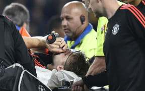 Luke Shaw receives oxygen before being carried off the field at Eindhoven