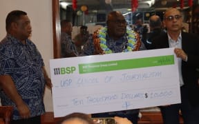 PINA president Kora Nou left, PNG’s Minister for Information & Communication Technology, Timothy Masiu and Head of the Journalism Program at USP, Associate Professor Dr Shailendra Singh, during the cheque presentation.