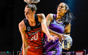 Jane Watson (left) and Paula Griffin battle for ball during the Tactix narrow win.