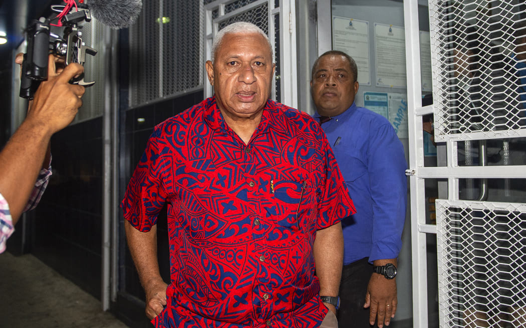 Fiji's former prime minister Frank Bainimarama (C) is taken into the Totogo Police remand centre in Suva on March 9, 2023. - Fiji's former prime minister Frank Bainimarama is due to appear in court on March 10 to face a charge of abuse of office, police said, months after an election removed him from power. (Photo by LEON LORD / AFP)