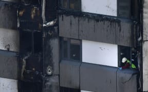 Untouched cladding on the burnt out upper floors of the Grenfell Tower block in a photo taken on 14 June 2017.