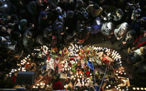 People visit a memorial to the two New York City police officers shot dead in their patrol car.