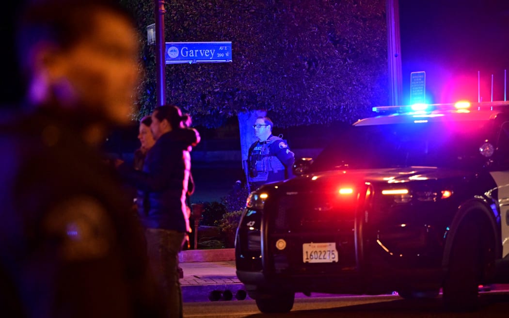 Police patrol the scene along Garvey Avenue in Monterey Park, California, on 21 January 21, 2023, where police are responding to reports of multiple people shot.