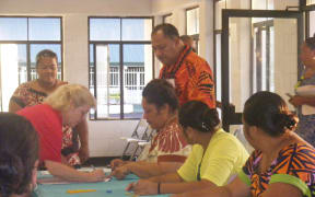A voter in American Samoa signs on the voter rolling at the Ili’ili polling station.