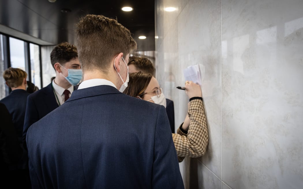 Watched by their fellow Youth MPs, Make-it-16 co-director Cate Tipler adds their signature to an open letter to Parliament that Youth MPs are signing - calling for the voting age to be lowered.